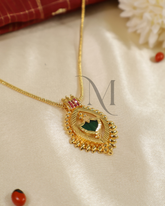 Regal Palakka Stone Pendant with Intricate Gold Framing