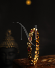 Regal Ruby-Studded Gold Bangle with Floral Accents