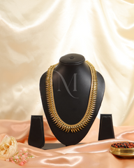 Striking Grace: Sculpted Spike Haram in Glossy Gold