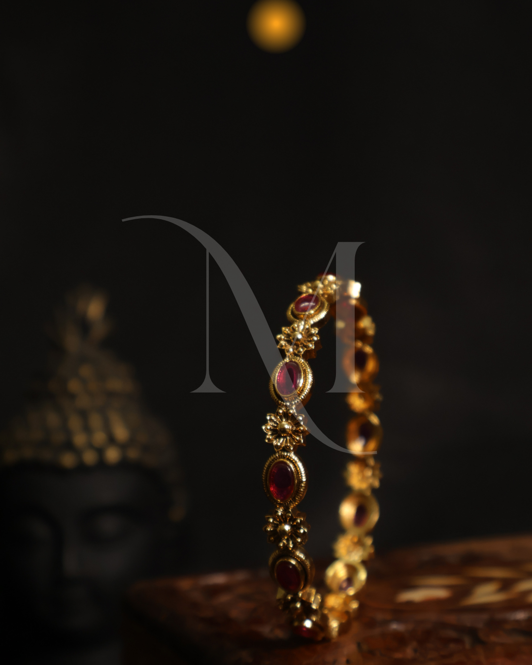 Regal Ruby-Studded Gold Bangle with Floral Accents